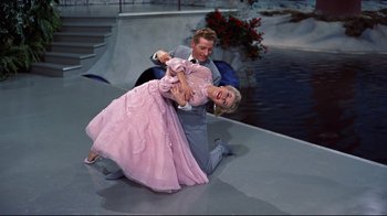 Movie still from “White Christmas” (1954), directed by Michael Curtiz – A man and a woman dressed in formal wear; Medium shot, High angle
