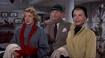 Movie still from “White Christmas” (1954), directed by Michael Curtiz – A group of people standing next to each other; Medium shot, Low angle
