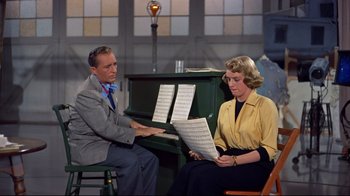 Movie still from “White Christmas” (1954), directed by Michael Curtiz – A man and a woman are sitting at a piano; Medium shot, High angle
