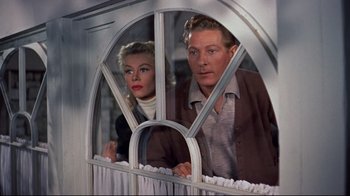 Movie still from “White Christmas” (1954), directed by Michael Curtiz – A man and a woman looking out of a window; Medium shot, Low angle