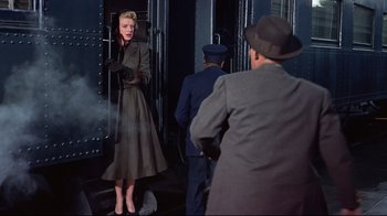 Movie still from “White Christmas” (1954), directed by Michael Curtiz – A woman standing in front of two men in a suit; Medium shot, Low angle