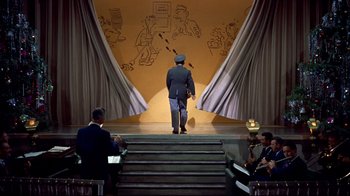 Movie still from “White Christmas” (1954), directed by Michael Curtiz – A man walking up stairs in front of a stage; Wide shot, Low angle