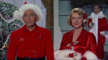 Movie still from “White Christmas” (1954), directed by Michael Curtiz – A man and a woman dressed up in christmas attire; Medium shot, Low angle