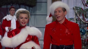 Movie still from “White Christmas” (1954), directed by Michael Curtiz – A man and a woman dressed up in christmas attire; Medium shot, Low angle