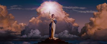 A statue of a woman holding a light in the sky