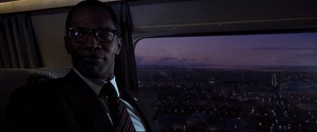 Movie still from “White House Down” (2013), directed by Roland Emmerich – A man wearing a suit and tie sitting in a helicopter at night; Close Up shot, Low angle