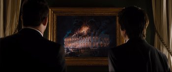 Movie still from “White House Down” (2013), directed by Roland Emmerich – A painting of a building on fire in a museum; Medium shot, Over the shoulder angle