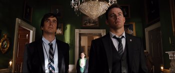 Movie still from “White House Down” (2013), directed by Roland Emmerich – Two men and a little girl standing in front of a chandelier; Medium shot, Low angle