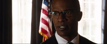 Movie still from “White House Down” (2013), directed by Roland Emmerich – A person wearing a suit and glasses; Close Up shot, Low angle