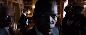 Movie still from “White House Down” (2013), directed by Roland Emmerich – A person wearing a suit and tie; Close Up shot, Low angle