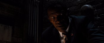 Movie still from “White House Down” (2013), directed by Roland Emmerich – A man wearing a suit and tie in the dark; Close Up shot, High angle