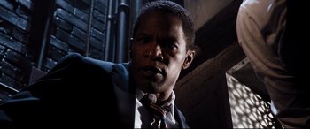Movie still from “White House Down” (2013), directed by Roland Emmerich – A person wearing a suit and tie; Close Up shot, Low angle