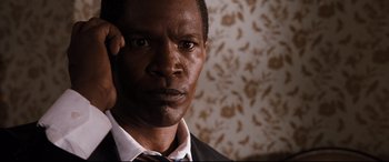 Movie still from “White House Down” (2013), directed by Roland Emmerich – A person wearing a suit and tie; Close Up shot, High angle