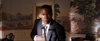 Movie still from “White House Down” (2013), directed by Roland Emmerich – A man in a suit and tie posing for a picture; Medium shot, High angle