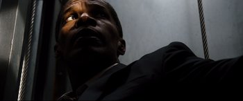 Movie still from “White House Down” (2013), directed by Roland Emmerich – A person wearing a suit and tie; Close Up shot, Low angle