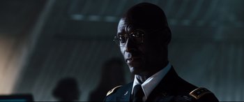 Movie still from “White House Down” (2013), directed by Roland Emmerich – A person wearing glasses and a uniform; Close Up shot, Over the shoulder angle