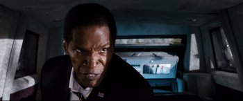 Movie still from “White House Down” (2013), directed by Roland Emmerich – A person in a suit and tie in a car; Close Up shot, High angle