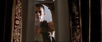 Movie still from “White House Down” (2013), directed by Roland Emmerich – A person looking through a window; Medium shot, Low angle