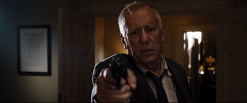 Movie still from “White House Down” (2013), directed by Roland Emmerich – An older man holding a gun in a room; Close Up shot, Low angle