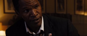 Movie still from “White House Down” (2013), directed by Roland Emmerich – A person wearing a suit and tie; Close Up shot, Over the shoulder angle