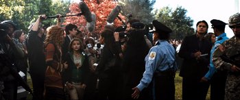 Movie still from “White House Down” (2013), directed by Roland Emmerich – A group of people standing around a crowd of people; Wide shot, Over the shoulder angle