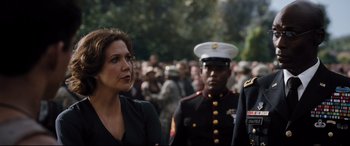 Movie still from “White House Down” (2013), directed by Roland Emmerich – A woman standing next to a man in a uniform; Medium shot, Over the shoulder angle
