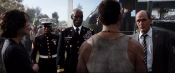 Movie still from “White House Down” (2013), directed by Roland Emmerich – A man in a military uniform standing next to another man; Medium shot, Over the shoulder angle