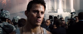Movie still from “White House Down” (2013), directed by Roland Emmerich – A person with a crowd of people in the background; Close Up shot, Low angle