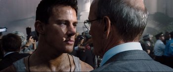 Movie still from “White House Down” (2013), directed by Roland Emmerich – A man and an older man talking to each other; Close Up shot, Over the shoulder angle