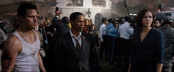 Movie still from “White House Down” (2013), directed by Roland Emmerich – A man in a suit and tie standing in front of a group of people; Medium shot, Over the shoulder angle