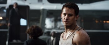 Movie still from “White House Down” (2013), directed by Roland Emmerich – A person wearing a tank top; Close Up shot, Over the shoulder angle