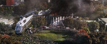 Movie still from “White House Down” (2013), directed by Roland Emmerich – A large crowd of people watching a house on fire; Extreme Wide shot, High angle