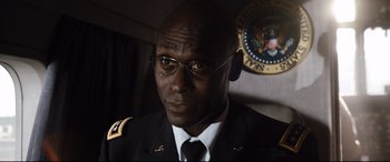 Movie still from “White House Down” (2013), directed by Roland Emmerich – A person wearing glasses and a uniform; Close Up shot, Low angle