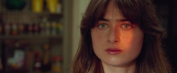 Movie still from “White Noise” (2022), directed by Noah Baumbach – A woman's face in a room; Close Up shot, High angle