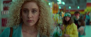 Movie still from “White Noise” (2022), directed by Noah Baumbach – A person with curly blonde hair; Close Up shot, Over the shoulder angle