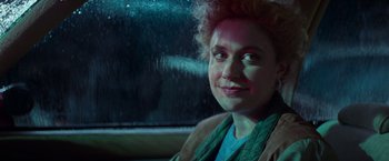 Movie still from “White Noise” (2022), directed by Noah Baumbach – A woman sitting in a car looking out the window; Close Up shot, Over the shoulder angle