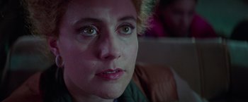 Movie still from “White Noise” (2022), directed by Noah Baumbach – A woman's face with green eyes; Close Up shot, Over the shoulder angle