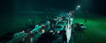 Movie still from “White Noise” (2022), directed by Noah Baumbach – A bunch of cars that are on the side of the road; Extreme Wide shot, High angle
