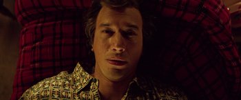 Movie still from “White Noise” (2022), directed by Noah Baumbach – A person wearing a shirt; Close Up shot, Overhead angle