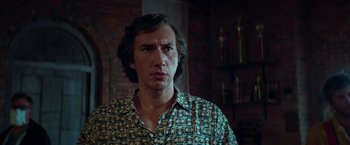 Movie still from “White Noise” (2022), directed by Noah Baumbach – A person wearing a button up shirt; Close Up shot, Low angle