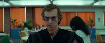 Movie still from “White Noise” (2022), directed by Noah Baumbach – A man in a black jacket and sunglasses; Close Up shot, Low angle