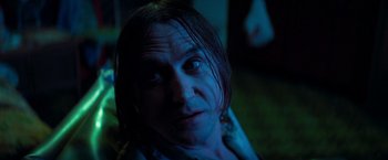 Movie still from “White Noise” (2022), directed by Noah Baumbach – A person's face in the dark; Close Up shot, Over the shoulder angle