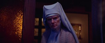 Movie still from “White Noise” (2022), directed by Noah Baumbach – A woman in a nun's outfit is looking at the camera; Close Up shot, Low angle