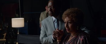 Movie still from “Whitney Houston: I Wanna Dance with Somebody” (2022), directed by Kasi Lemmons – A man and a woman standing next to each other; Medium shot, Over the shoulder angle