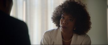 Movie still from “Whitney Houston: I Wanna Dance with Somebody” (2022), directed by Kasi Lemmons – A person wearing a white shirt; Close Up shot, Over the shoulder angle