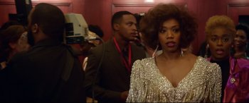 Movie still from “Whitney Houston: I Wanna Dance with Somebody” (2022), directed by Kasi Lemmons – A man and a woman standing next to each other in a room; Medium shot, Low angle