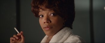 Movie still from “Whitney Houston: I Wanna Dance with Somebody” (2022), directed by Kasi Lemmons – A person wearing a white robe; Close Up shot, Over the shoulder angle