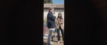 Movie still from “Windfall” (2022), directed by Charlie McDowell – A man and a woman standing next to each other; Wide shot, Over the shoulder angle