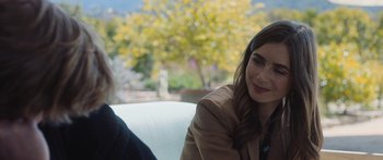 Movie still from “Windfall” (2022), directed by Charlie McDowell – A woman sitting next to another woman in a car; Close Up shot, Over the shoulder angle