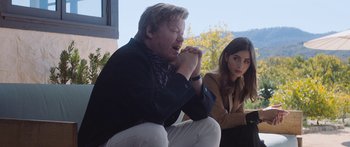 Movie still from “Windfall” (2022), directed by Charlie McDowell – A man and a woman sitting next to each other; Medium shot, Over the shoulder angle